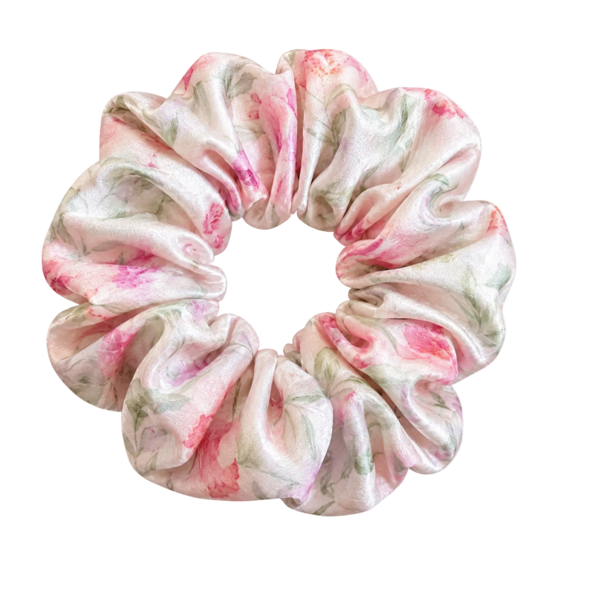 A mulberry silk hair scrunchie with a soft, gathered texture, featuring a watercolor floral pattern in pink and green on a light cream background, isolated on a transparent backdrop.