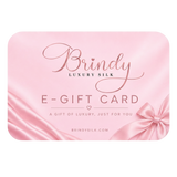 A pink e-gift card with a satin-like finish, featuring the brand name 'Brindy' in elegant cursive, 'LUXURY SILK' in smaller text, and 'E-GIFT CARD' with a bow illustration in the lower right corner.