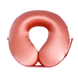 A U-shaped inflatable travel neck pillow in a coral, shown against a solid white background.