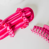 Hot pink Brindy Mulberry Silk heatless hair roller set with a claw clip and a white background
