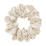 white ivory colored silk scrunchie with embedded rhinestones on a white background