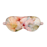 Peach Floral patterned silk sleep mask on a white background