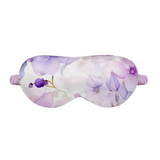 Floral patterned silk sleep mask on a white background