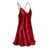 A red mulberry silk slip dress with thin crisscross spaghetti straps and a V-neckline, shown against a transparent checkered background.