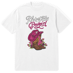 A white short-sleeve t-shirt with a rhinestone-style graphic on the front reading 'Rhinestone Cowgirl' in silver and pink lettering above a pink cowboy hat, brown cowboy boots, and pink flowers.