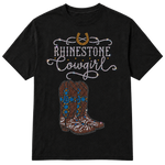 A black short-sleeve t-shirt with a rhinestone-style graphic on the front featuring a horseshoe, the words 'RHINESTONE Cowgirl' in white script, and a pair of cowboy boots in brown, blue, and white rhinestones on a transparent background.