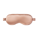 Rose gold silk sleep mask on a white background