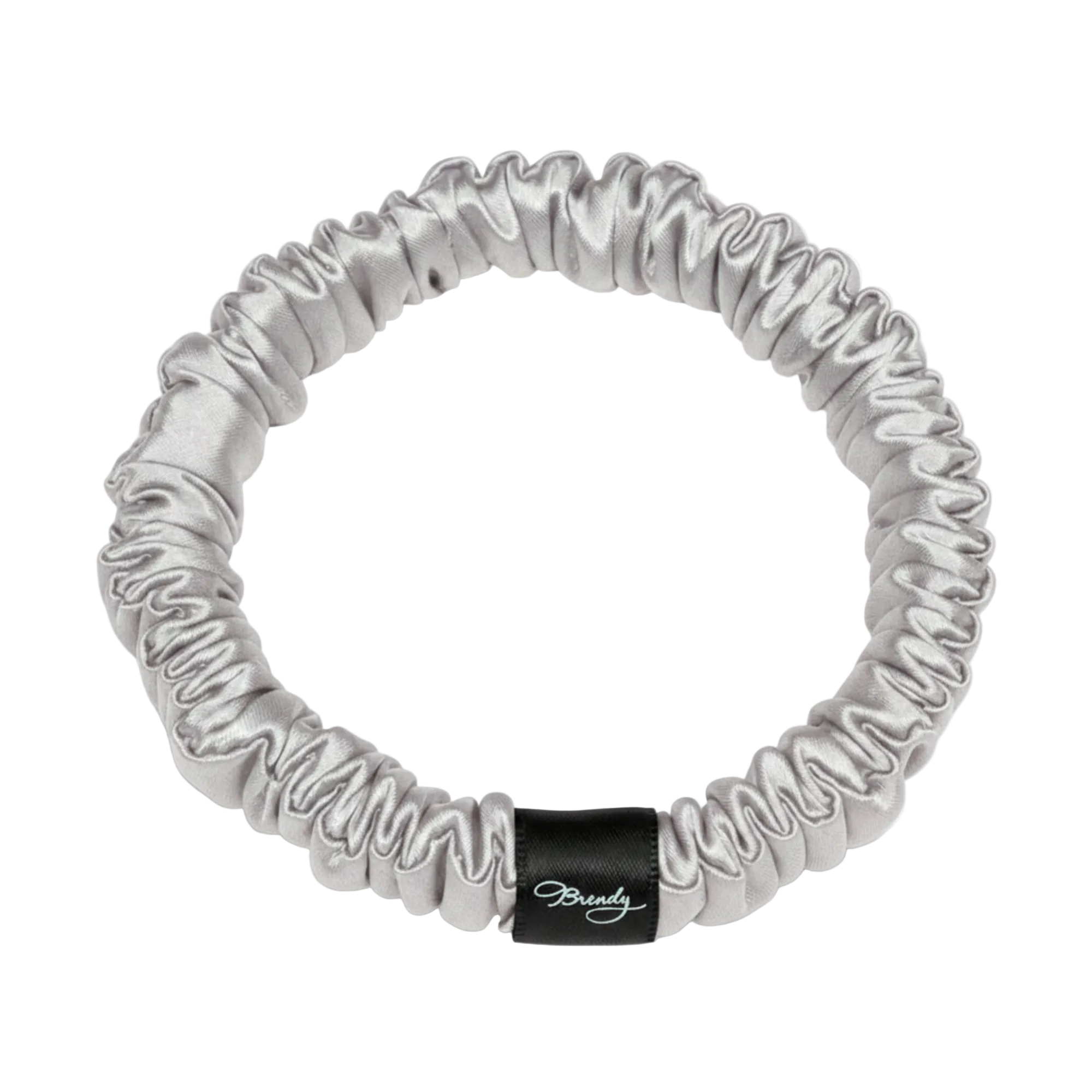 Silver skinny silk scrunchie with a black Brindy Label on a white background