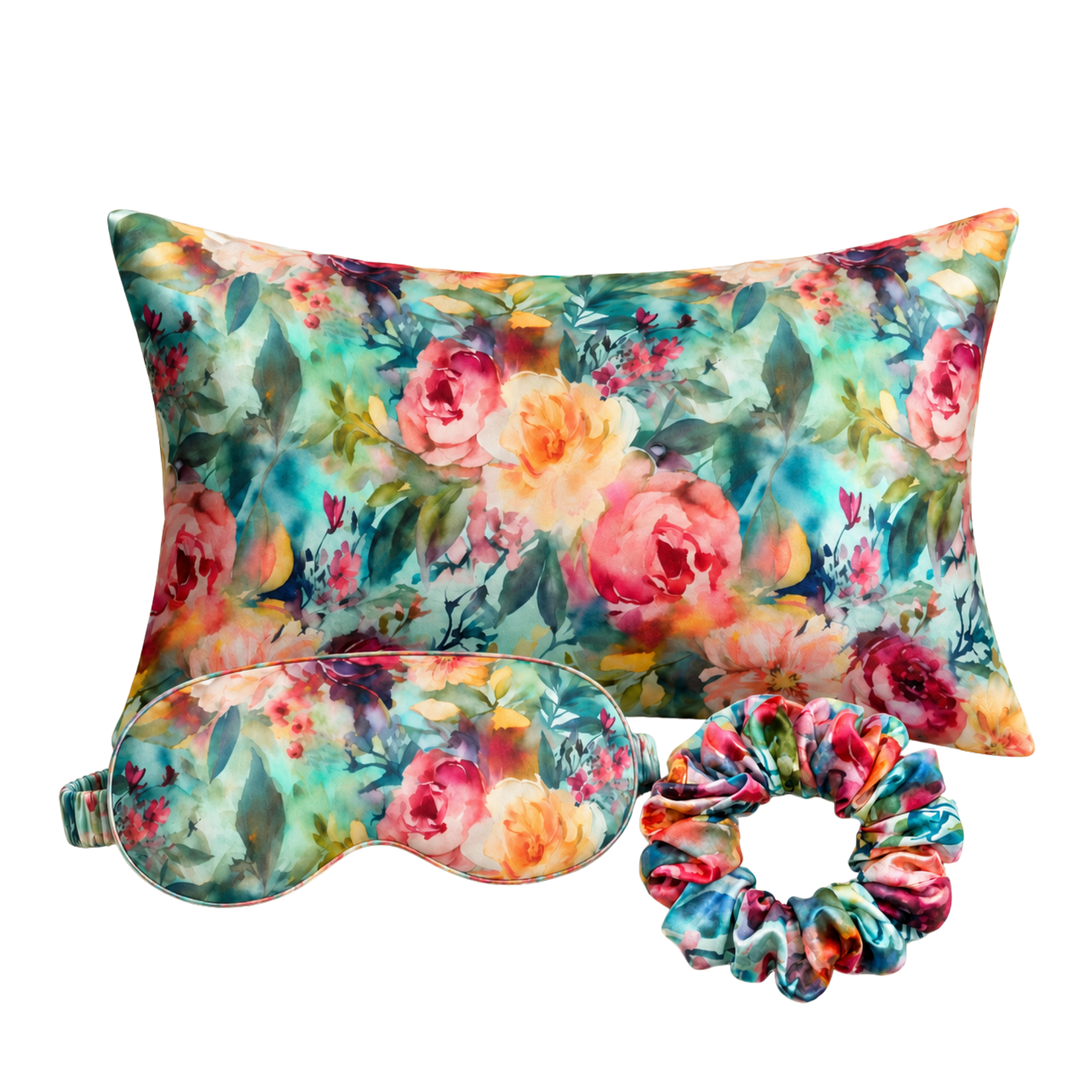 A floral-themed mulberry silk sleep set featuring a rectangular pillow, a matching eye mask, and a scrunchie, all decorated with a colorful watercolor-style rose pattern on a white background.
